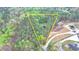 Aerial view of a property nestled in a wooded area, highlighting the home, pool, and surrounding landscape at 311 Maranatha Trl, Lawrenceville, GA 30045
