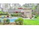A beautiful backyard featuring an in-ground pool, deck area, and lush landscaping, perfect for outdoor entertaining at 311 Maranatha Trl, Lawrenceville, GA 30045