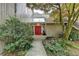 Charming home with a red door, mature landscaping, and a welcoming entrance at 311 Maranatha Trl, Lawrenceville, GA 30045