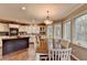 Bright kitchen and dining area with an island, featuring a large window and hardwood flooring at 311 Maranatha Trl, Lawrenceville, GA 30045