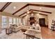 Bright living room featuring exposed wood beams, stone fireplace, and large windows with nature view at 311 Maranatha Trl, Lawrenceville, GA 30045