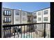 View of apartment building exterior from balcony, showing pool and courtyard at 5300 Peachtree Rd # 2309, Chamblee, GA 30341