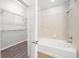 Bathroom featuring combination tub and shower with access to walk-in closet at 5300 Peachtree Rd # 2309, Chamblee, GA 30341