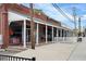 A storefront with outdoor seating featuring a white picket fence and modern architectural elements at 5300 Peachtree Rd # 2309, Chamblee, GA 30341