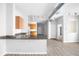 Open-concept kitchen featuring modern appliances, granite countertops, wood cabinets and track lighting at 5300 Peachtree Rd # 2309, Chamblee, GA 30341