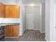 Compact kitchen area featuring wooden cabinets, granite countertops and wood-look flooring at 5300 Peachtree Rd # 2309, Chamblee, GA 30341