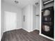 Laundry area with stacked washer/dryer, white door, and dark hardwood-style flooring at 5300 Peachtree Rd # 2309, Chamblee, GA 30341