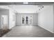 Bright living area showcasing sleek gray hardwood floors, track lighting, and access to an outdoor balcony at 5300 Peachtree Rd # 2309, Chamblee, GA 30341