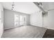Spacious living room with hardwood floors and natural light, featuring modern track lighting and a walk-out balcony at 5300 Peachtree Rd # 2309, Chamblee, GA 30341