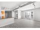 Well-lit open concept living room featuring gray flooring, track lighting, and balcony access at 5300 Peachtree Rd # 2309, Chamblee, GA 30341