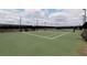 Community tennis court with bright green surface and lighting for nighttime play at 5300 Peachtree Rd # 2309, Chamblee, GA 30341