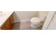 Small bathroom with wooden vanity, sink, and toilet at 72 Belmonte Sw Cir, Atlanta, GA 30311