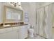 Bathroom showcasing modern vanity, framed mirror, and patterned shower curtain offering a functional and stylish design at 91 Webb St, Roswell, GA 30075