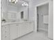 Elegant bathroom featuring double sinks, a large mirror, and a separate linen closet at 91 Webb St, Roswell, GA 30075