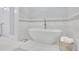 Elegant bathroom featuring a freestanding tub and marble tile accents creating a luxurious spa-like atmosphere at 91 Webb St, Roswell, GA 30075