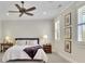 Spacious bedroom featuring a ceiling fan, bright windows, and two bedside tables at 91 Webb St, Roswell, GA 30075