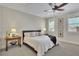 Cozy bedroom with natural light, a ceiling fan, neutral walls, and decorative side tables at 91 Webb St, Roswell, GA 30075
