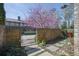 Picturesque courtyard with a brick wall, iron gate, stepping stone path, and lush plantings at 91 Webb St, Roswell, GA 30075