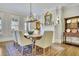 Dining room with hardwood floors, a fireplace, and natural light from nearby windows at 91 Webb St, Roswell, GA 30075