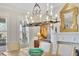 Bright dining room features a decorative chandelier, large windows, and a fireplace with a gold mirror at 91 Webb St, Roswell, GA 30075