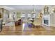 Open concept living and dining area with hardwood floors, a fireplace, and natural light at 91 Webb St, Roswell, GA 30075