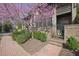 Charming brick townhome featuring lush landscaping and an inviting gated entrance at 91 Webb St, Roswell, GA 30075
