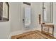Light-filled foyer with wood floors, decorative mirror, and shuttered door at 91 Webb St, Roswell, GA 30075