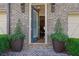 Elegant entrance with blue door, brick facade, and decorative planters at 91 Webb St, Roswell, GA 30075