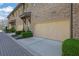 Brick townhome featuring attached garage, professional landscaping, and manicured bushes at 91 Webb St, Roswell, GA 30075