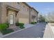 Street view of attached garage brick townhomes with professionally landscaped yards at 91 Webb St, Roswell, GA 30075