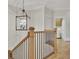 Hallway with hardwood floors, staircase, and a decorative chandelier hanging above at 91 Webb St, Roswell, GA 30075