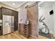 Modern kitchen with stainless steel appliances and wine storage area next to home gym at 91 Webb St, Roswell, GA 30075