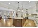 Open-concept kitchen with a large island, granite countertops, and hardwood floors at 91 Webb St, Roswell, GA 30075