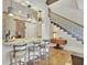Modern kitchen with stainless steel appliances and bar seating area next to stairs at 91 Webb St, Roswell, GA 30075