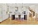 Open-concept kitchen featuring a large island, white cabinetry, and stainless appliances at 91 Webb St, Roswell, GA 30075