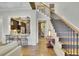 Open floor plan with staircase and bar area creating a seamless flow between living spaces with natural light at 91 Webb St, Roswell, GA 30075
