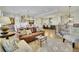 Open-concept living room with hardwood floors, comfortable seating, and a view into the kitchen at 91 Webb St, Roswell, GA 30075