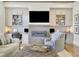 Living room with built-in cabinets, fireplace, and comfortable seating, creating a cozy and functional living space at 91 Webb St, Roswell, GA 30075