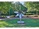 Metal flower statue on a manicured lawn at a public park, with benches and tables in the background at 91 Webb St, Roswell, GA 30075