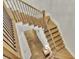 Staircase featuring hardwood steps, wrought iron spindles, and a landing offering a view of the lower level at 91 Webb St, Roswell, GA 30075
