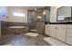 Modern tiled bathroom with a soaking tub, glass shower, vanity, and black countertops at 112 Austin Dr, Sandy Springs, GA 30328