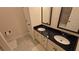 Elegant bathroom featuring double sinks, black granite countertop, and framed mirrors at 112 Austin Dr, Sandy Springs, GA 30328