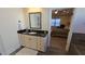 Bright bathroom featuring a vanity with a black countertop and an open doorway to the main bedroom at 112 Austin Dr, Sandy Springs, GA 30328