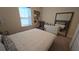 Comfortable bedroom with soft carpet, featuring a queen bed, nightstand, dresser, large mirror and a framed wall print at 112 Austin Dr, Sandy Springs, GA 30328