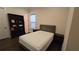 Cozy bedroom featuring a comfortable bed, dark wood bookshelf and hardwood floors at 112 Austin Dr, Sandy Springs, GA 30328