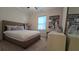 Comfortable bedroom with soft carpet, featuring a queen bed, nightstand, dresser, and a decorative framed wall print at 112 Austin Dr, Sandy Springs, GA 30328