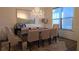 Elegant dining room featuring a crystal chandelier, large mirror and seating for eight people at 112 Austin Dr, Sandy Springs, GA 30328