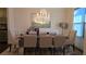Elegant dining room featuring a crystal chandelier, large mirror and seating for eight people at 112 Austin Dr, Sandy Springs, GA 30328
