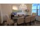 Elegant dining room featuring a crystal chandelier, large mirror and seating for eight people at 112 Austin Dr, Sandy Springs, GA 30328
