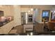 Open-concept kitchen with stainless steel appliances, dark countertops, and white cabinets seamlessly connects to other living areas at 112 Austin Dr, Sandy Springs, GA 30328